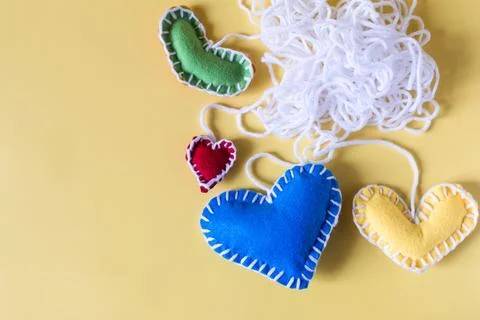 Abstract background a ball of white threads with colored hearts. Stock Photos