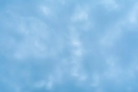 Abstract background based on clouds of uncertain shape in light blue sky Foto stock