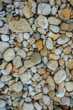 Abstract background beach with large and small pebbles. View from above Stock Photos