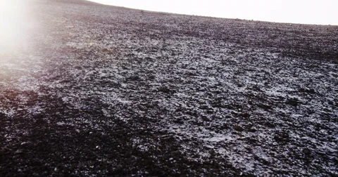 Abstract background black desert rock with ice and sun flare in the background Видео 64680536