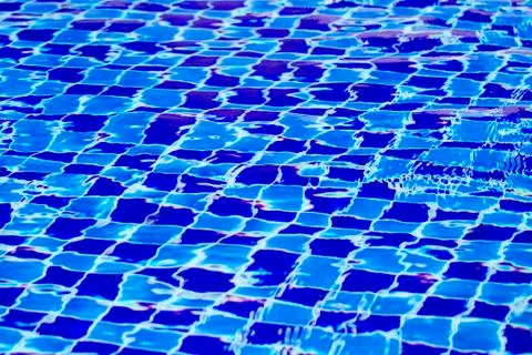 Abstract background from blue tiled pool with clear rippling water Stockfoto's