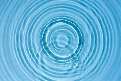 Abstract background, blue water texture with round ripples, close up Stock Photos