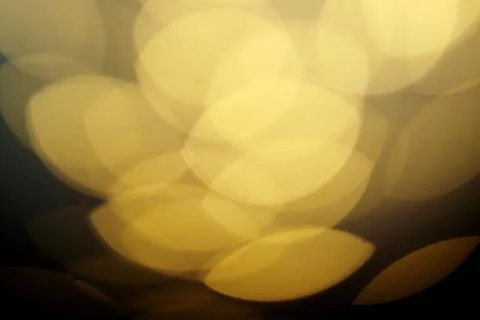 Abstract background with bokeh effects in pale yellow tones.. Stock Photos