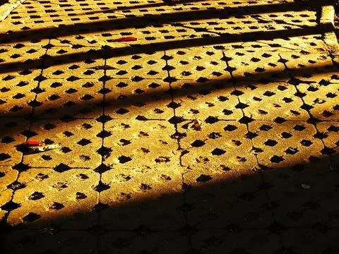 Abstract background of a brick sidewalk with a shadow cast on it Stock Photos