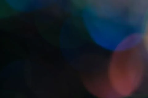 Abstract background of bright multi-layered bokeh on a dark background. Stock Photos