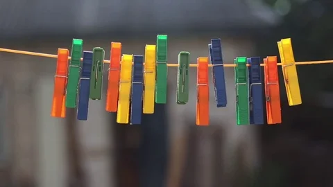 Abstract background with close up clothespins hanging on rope in wind. Stock Footage 78770974