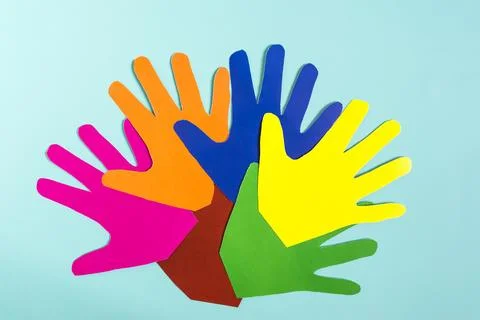 Abstract background colored paper hands on a blue background. Stock Photos