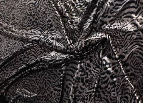 Abstract background composed of leopard print fabric. Stock Photos
