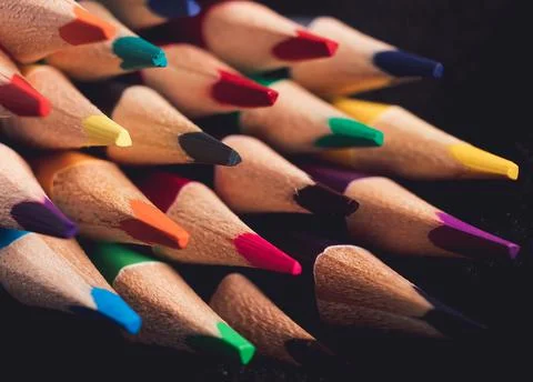 Abstract background for creativity. Lots of colored pencils on a dark background Stockfoto's