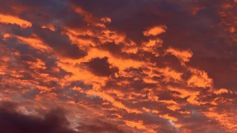 Abstract background of a dramatic sunset sky featuring intense glowing fiery Stock Photos