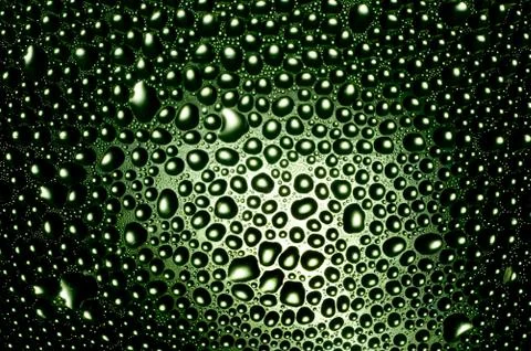 Abstract background, drops on a backlighted green glass Fotos Stock