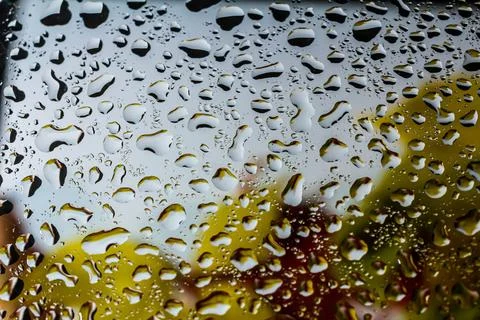 Abstract background fall, glass drops autumn yellow leaves wet october weathe 库存照片