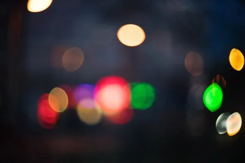 Abstract background featuring colorful glowing bokeh lights in the dark night Stock Photos