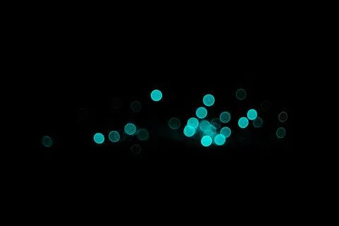 Abstract background featuring glowing cyan and blue bokeh light circles on .. Stock Photos