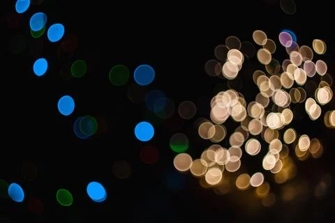 Abstract background featuring glowing golden and blue light bokeh spots aga.. Stock Photos