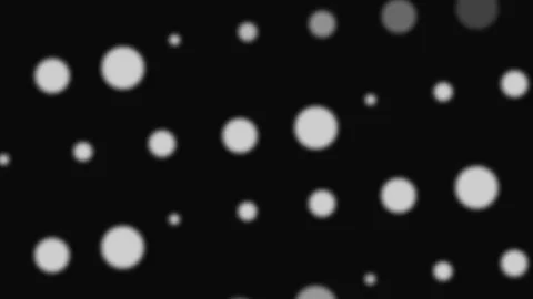 Abstract background featuring soft glowing white bokeh circles on black Video stock 335117197