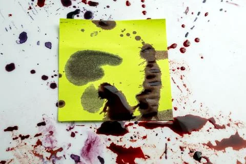 Abstract background featuring a yellow note covered in dark red blood splat.. Stock Photos