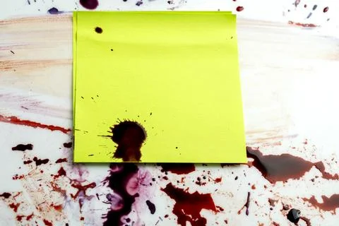 Abstract background featuring a yellow note covered in dark red blood splat.. Stock Photos