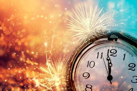 Abstract background with fireworks and clock close to midnight 库存照片