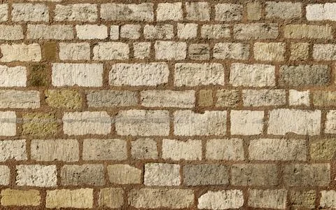 An abstract background formed by a flat wall of regularly shaped stones with  Stock Photos