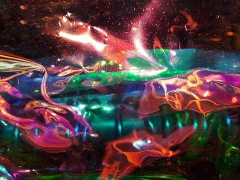 Abstract background with glossy glowing texture in red turquoise pink and ora Stock Photos