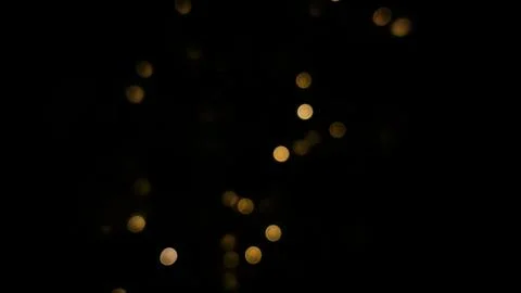Abstract background with golden bokeh features warm glowing dots. Stock Photos