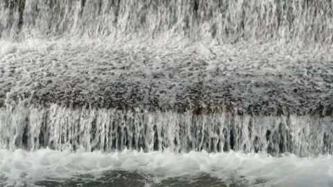 Abstract background, Graphic elements, Bubbling water flows quickly over a weir, Stock Footage 298087148
