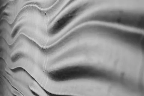 Abstract background: Graphite gray wavy texture. Decorative wall decoration Stock Photos