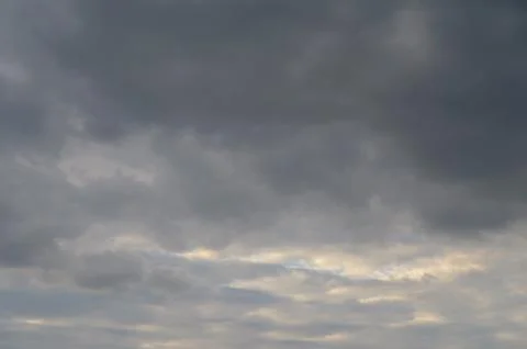Abstract background of gray fluffy clouds on a bright blue sky Stock Photos