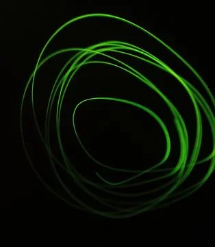 Abstract background with green glowing lines. Long exposure. Light painting. Stock Illustration