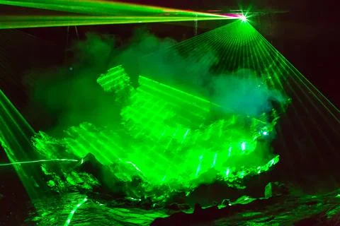 Abstract background with green laser rays and smoke Foto stock