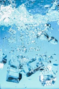 Abstract background image of ice cubes in blue water. Stock Photos