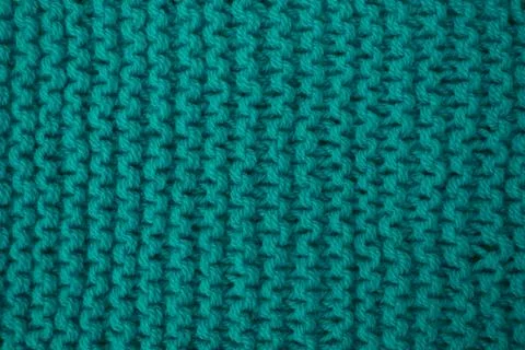 Abstract background of knitted woolen threads close-up. Stock Photos