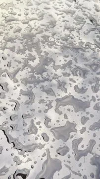 Abstract background of large, connected water drops and reflective puddles .. Stock Photos