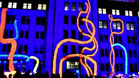 ABSTRACT BACKGROUND OF LIGHTS MOVING, BLURS AND COLOURS IN BUILDING, NIGHT SCENE Stock-Footage 131707821