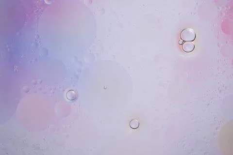 Abstract background in lilac soft tones. Macro drops of oil on the surface of Stock Photos
