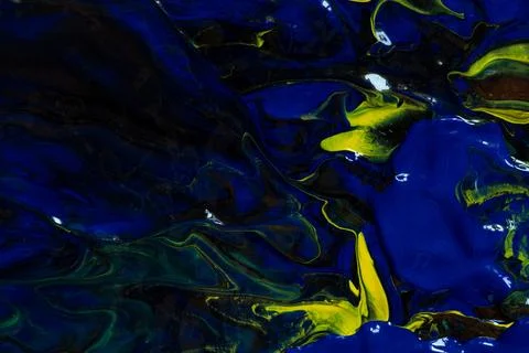 Abstract background made from a mix of blue, yellow and brown acrylic paint w Stock Photos