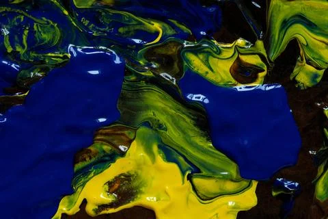 Abstract background made from a mix of blue, yellow and brown acrylic paint w Stock Photos