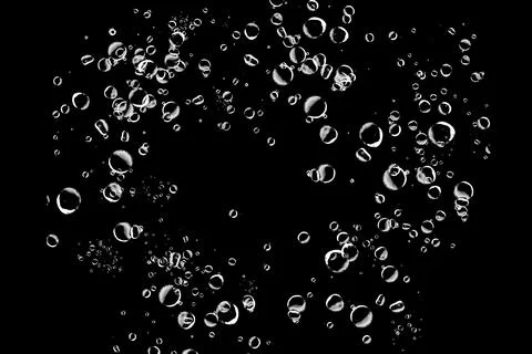 Abstract background of many white bubbles floating on a black background. P.. Stock Photos