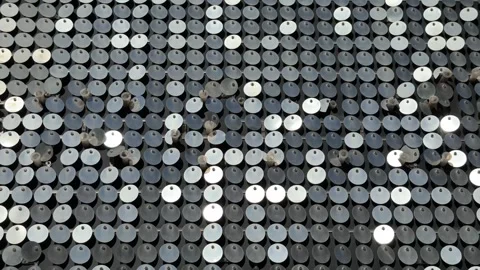 An abstract background of mirrored circular elements reflecting sunlight Stock Footage 335362387