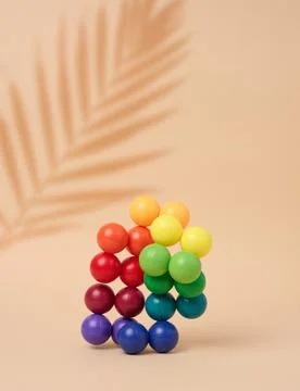 Abstract background with multi-colored plastic balls on a beige background,.. Stock Photos