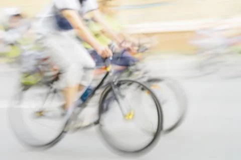 Abstract background of multiple cyclists in motion during fast-paced urban .. Stock Photos