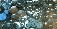Abstract Background. Oil, Water, Dye. Bubbling Liquid Stock Footage
