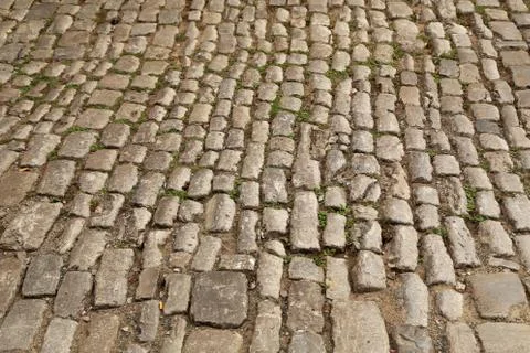 Abstract background of old cobblestone pavement close-up Stock Photos
