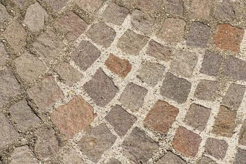 Abstract background of old cobblestone pavement close-up Stock Photos