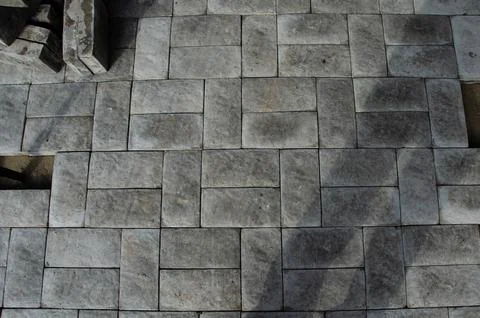 Abstract background of old cobblestone pavement close-up. Stock Photos