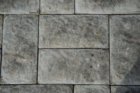 Abstract background of old cobblestone pavement close-up. Stock Photos