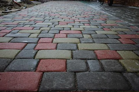 Abstract background of old cobblestone pavement close-up. Stock Photos