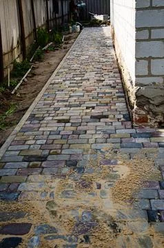 Abstract background of old cobblestone pavement close-up. Stock Photos
