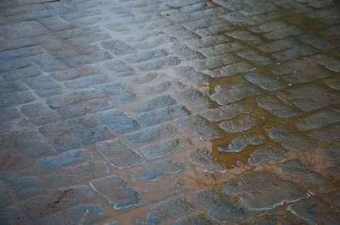 Abstract background. Old cobblestone pavement close-up. City Stock Photos